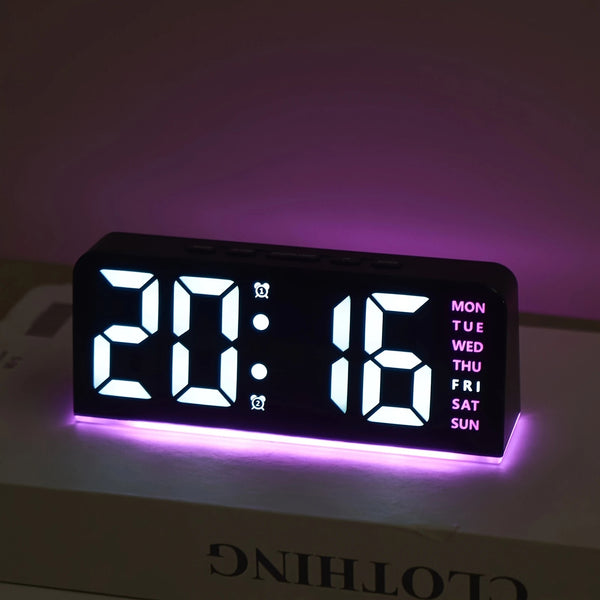 Digital clock with LED display on a white surface with a purple background